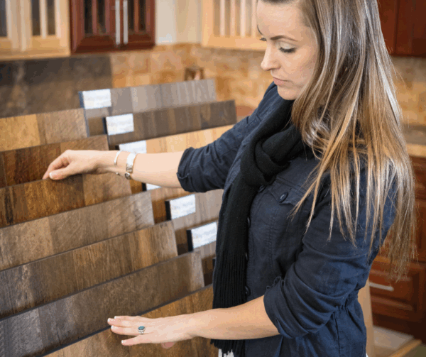 Woman selecting wooden planks for interior design