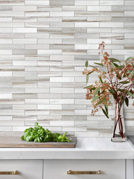 Modern kitchen design featuring a stylish tile backsplash and fresh herbs on a countertop.